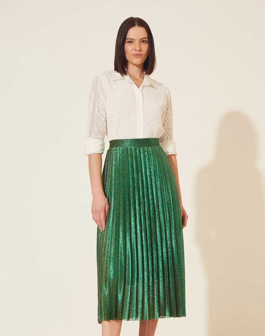 Saia Desirée confeccionada em lamê. <br>
Peça plissada, de comprimento midi e modelagem evasê. <br>