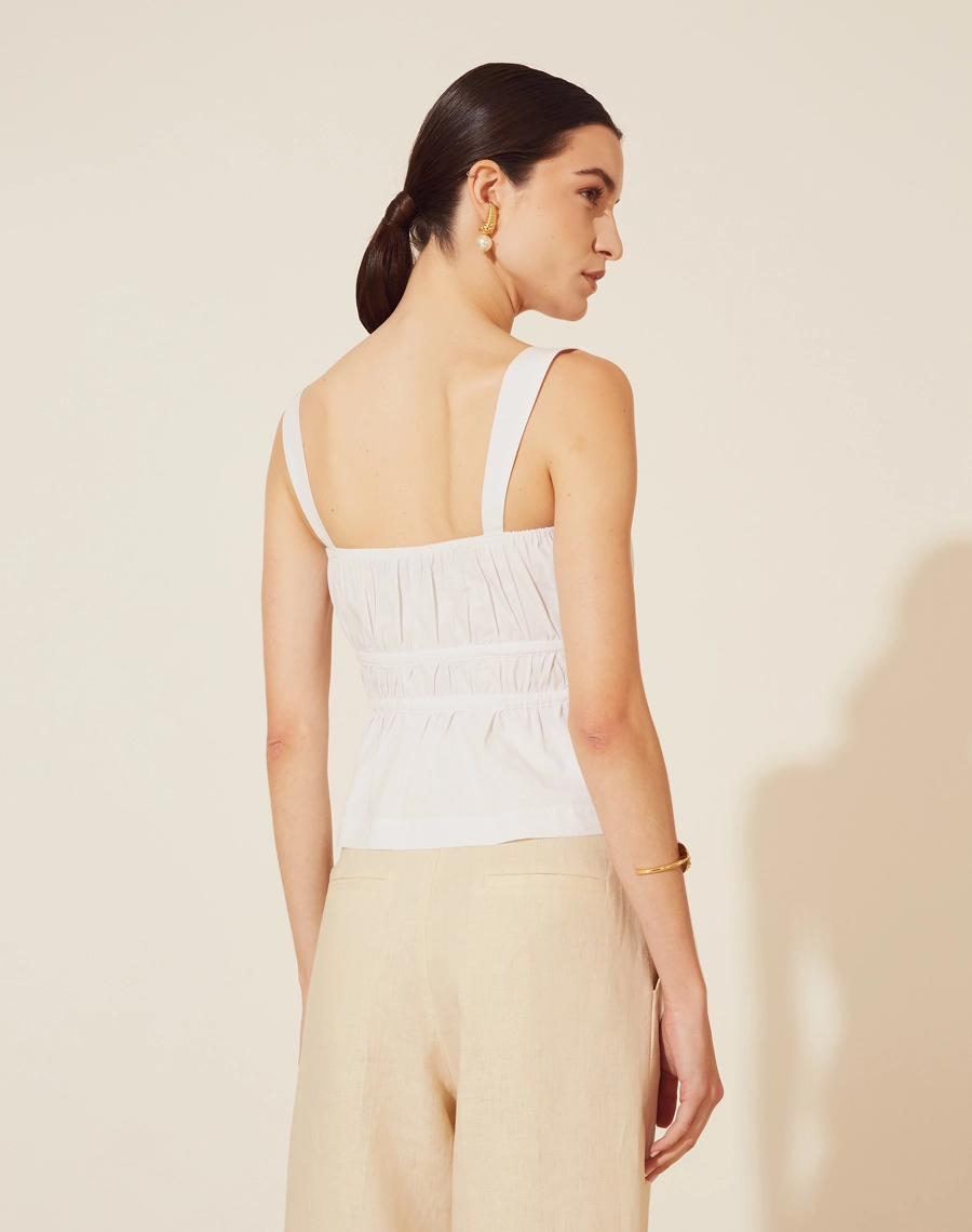 Blusa Tania confeccionado em cotton supreme, tecido mais estruturado. 
Possui decote quadrado e alças largas, possui pregas frontais e detalhe de passante por toda a cintura com cordão para amarração podendo deixara a peça mais acinturada.  Seu fechamento é por botão de casa frontal. 
Possui elástico interno no decote atrás. Peça mais estruturada e confortável ao corpo.