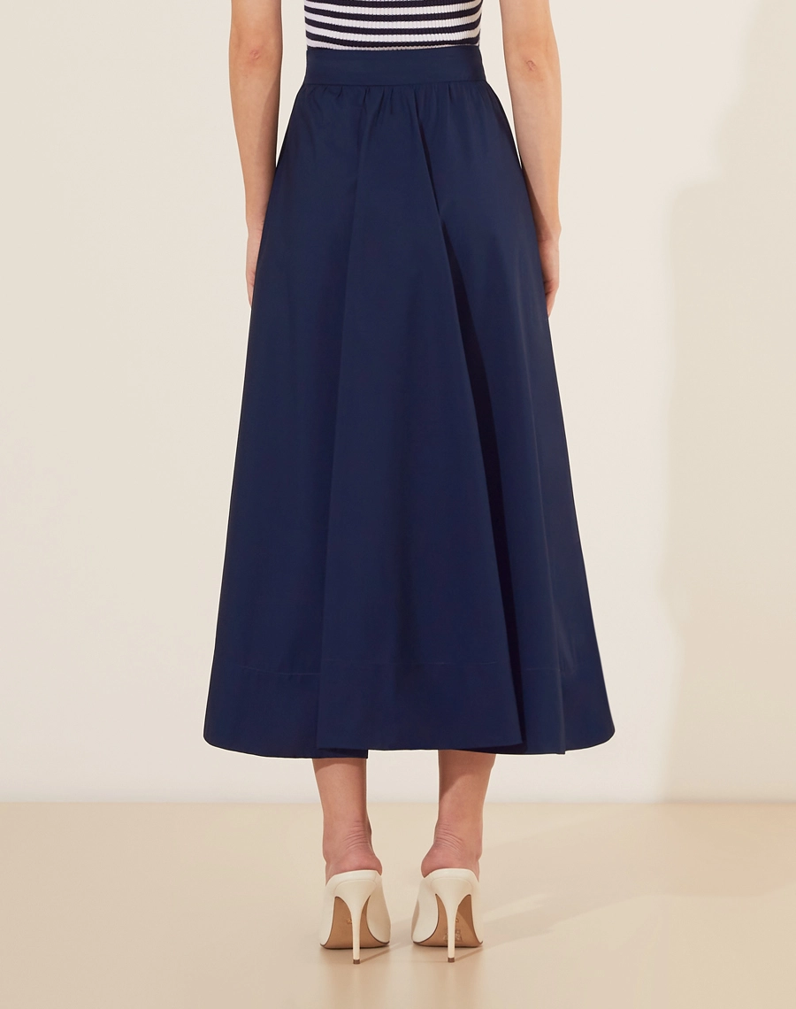 Saia Midi Yasmin confeccionada em Tricoline. <br/>
Sua cintura é alta, com pregas, modelagem evasê e barra reta.<br/>
Fechamento por zíper invisivel lateral. <br/>