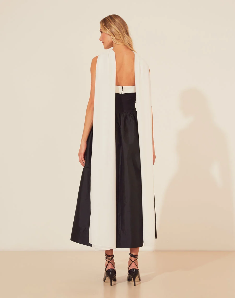 Vestido Midi Gloria é confeccionado em Tecno Prada no corpete e com uma saia volumosa de tafetá. O modelo destaca-se pelo caimento impecável, sendo deal para ocasiões que pedem estilo e conforto. 