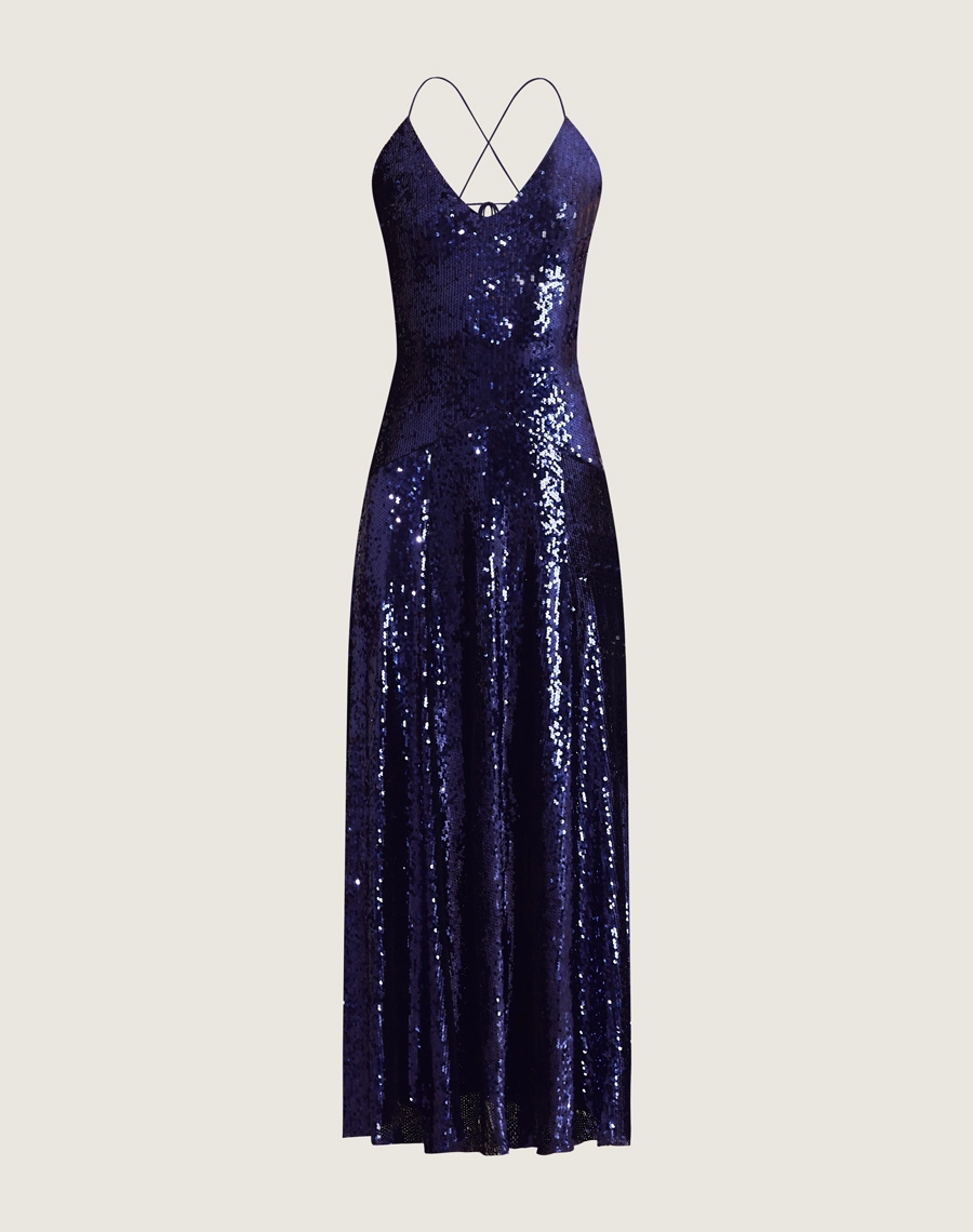 Vestido longo de paetê com alças cruzadas, decote em V e caimento fluido. Glamour e conforto para festas e eventos sofisticados.