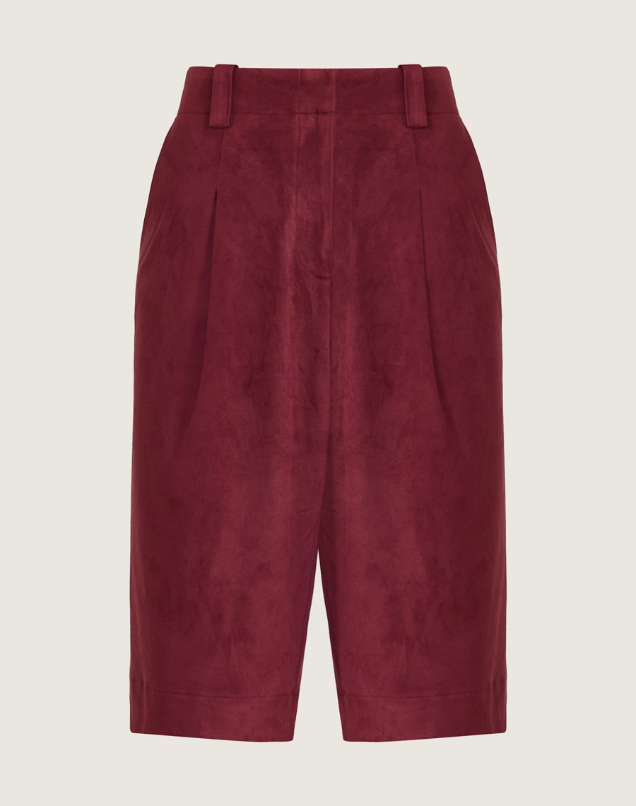 A Bermuda Elora é confeccionada em suede, um tecido conhecido pelo toque macio e acabamento levemente aveludado que remete à camurça.