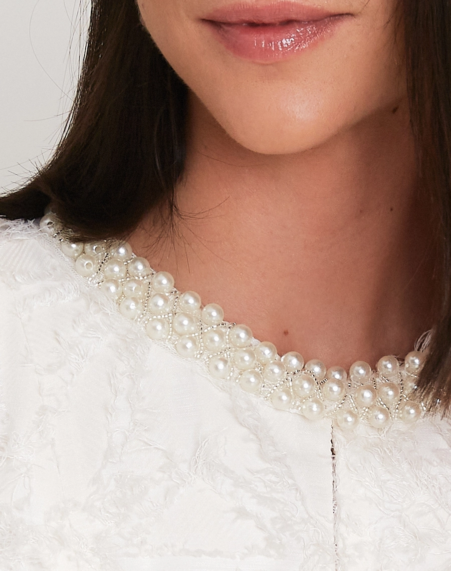 A Blusa Clarisse confeccionada em Tecido Jacquard Diagonal com textura rica e sofisticada, destacando desenhos em relevo que trazem profundidade e um visual refinado à peça.