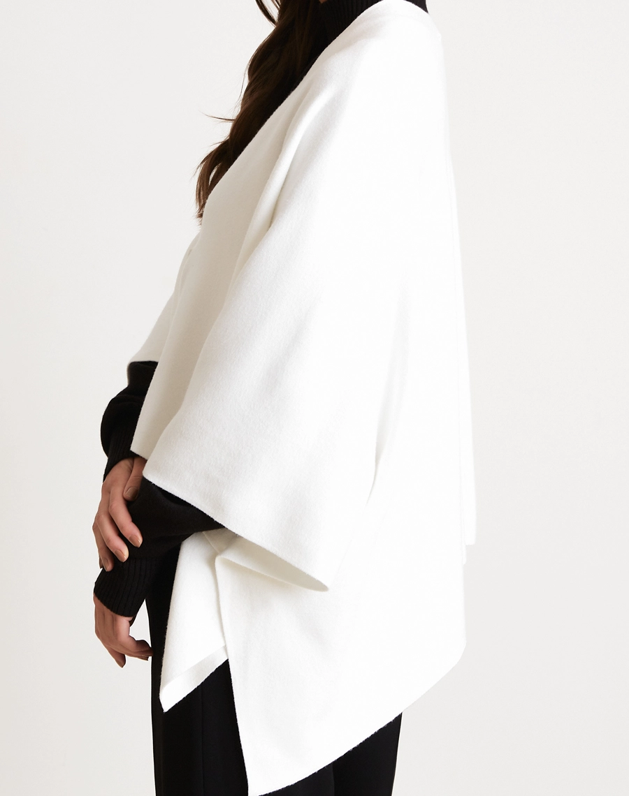 Poncho Liza confeccionado em tricô, tecido leve, com toque macio e caimento fluido que proporciona conforto e elegância.